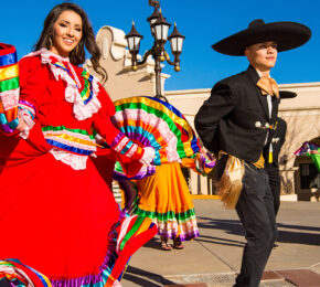 A group of Mexican dancers in colorful costumes, perfect for celebrating Cinco de Mayo.