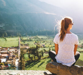 A woman is overlooking a village in South America.