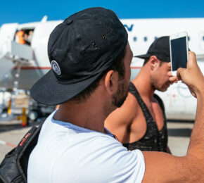 man taking photo of plane