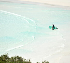 A person is surfing on a beach in Western Australia.