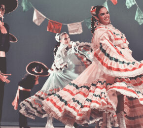 A group of Mexican dancers showcasing their experiences in Mexico on stage.