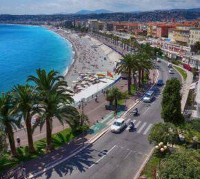 An aerial view of the beach in Nice, France showcasing nearby restaurants.