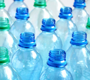 A group of blue and green plastic bottles, commonly used for beverages or other liquids.