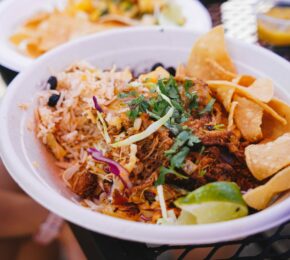 A bowl of Mexican food, known for being the best in Costa Rica, sitting on a table.