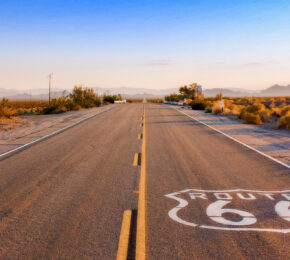 An empty road with a LA sign painted on it.