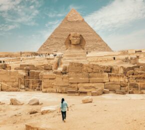 Person walking toward the Pyramids of Giza, Egypt