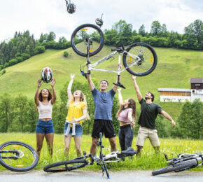 A group of people posing with their bicycles, showcasing things to do in Austria.