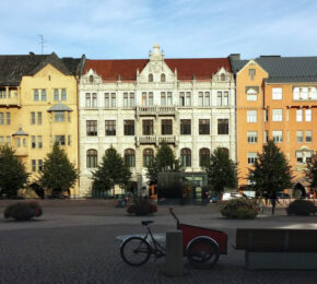 A brick building in the middle of a square to visit in Finland.