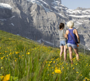 what to pack for a holiday in switzerland - image of two girls looking over the mountains in Switzerland