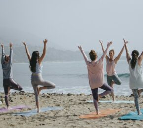 yoga on the beach during yoga retreat