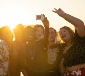 group of friends at sunset on a beach