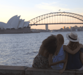 Travellers resting by waterfront in Sydney, Australia