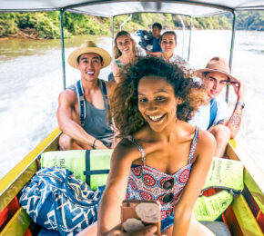 group of travellers enjoying a boat ride in South East Asia