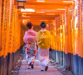 Japanese women in kimonos walking to Fushimi Inari Shrine in Japan