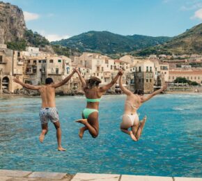 friends jumping into the water