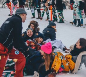 people laughing together in snow in Finland