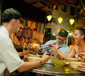 Contiki travellers in Vietnam eating food