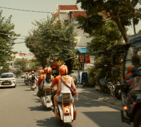 Contiki travellers on the back of vespas in Vietnam