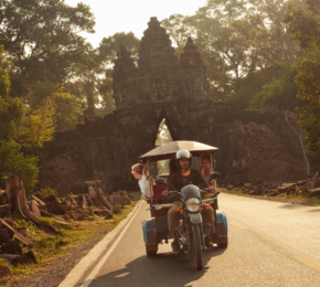travellers on tuktuk driving through Cambodia in southeast asia