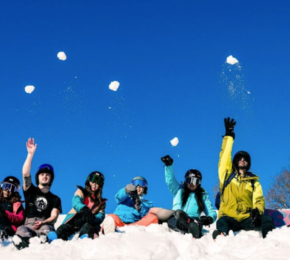 travellers throwing snowballs in air