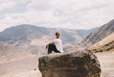 Girl sitting on rock