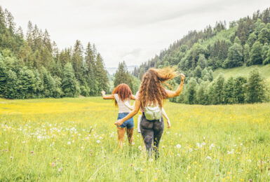 Two girls running through fields