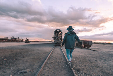 Woman walking on abandoned train tracks
