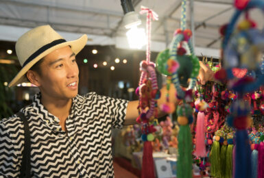 Man shopping for souvenirs in Asia