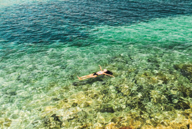 Woman floating in the sea on a Contiki