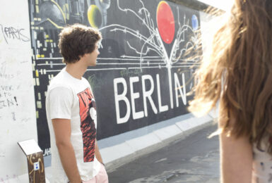 Two people in front of graffiti