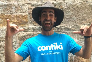 A man wearing a hat and t-shirt with the word contiki on it wins Cosmo Bachelor of the Year.