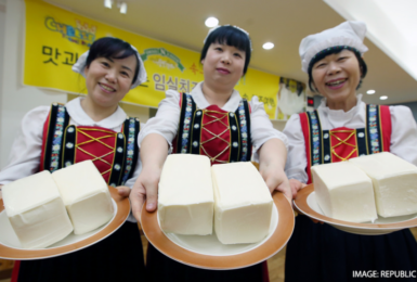 A group of women holding plates of cheese.
