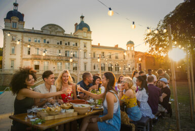 Contiki Chateau, group of friends eating and drinking at dusk