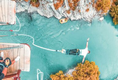 man bungee jumping off suspension bridge