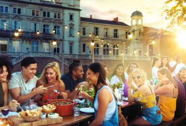 friends eating a meal on a balcony