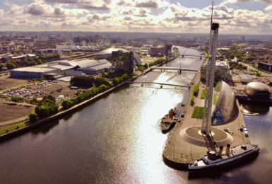 A boat is docked near a city.