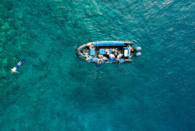 An aerial view of a boat in the ocean near Hawaii.