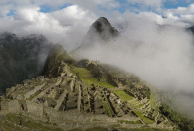 The ruins of Machu Picchu are covered in clouds while hiking the Inca Trail.