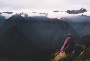 A person hiking the Inca Trail to reach the top of a mountain.