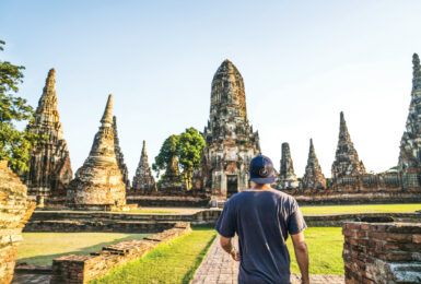 A man walking through a temple in Thailand.