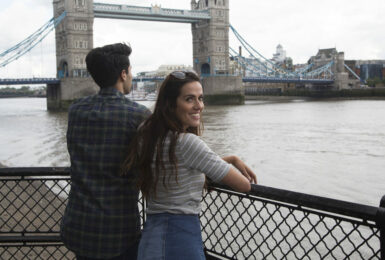 A couple traveling in the UK admiring Tower Bridge in London.