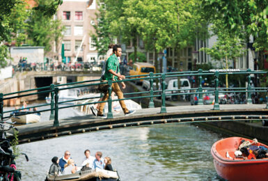 three young people walking in amsterdam