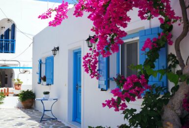 white house with blue windows in antiparos, greece