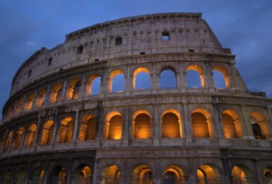         The colosseum is lit up at night.