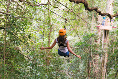 A woman on a zip line in Thailand.