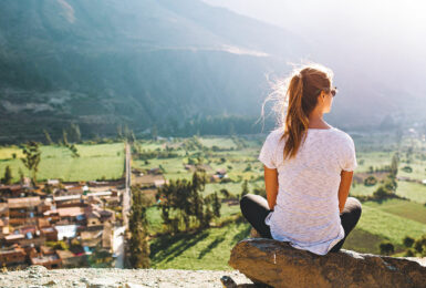 A woman is overlooking a village in South America.