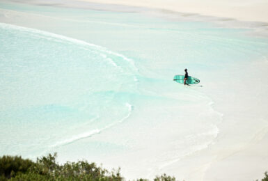 A person is surfing on a beach in Western Australia.