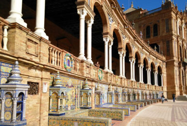 An ornate building with tiled walkways in Seville.