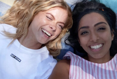 Two women keeping their mental health in check while enjoying a beach day during Covid-19.