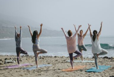 yoga on the beach during yoga retreat